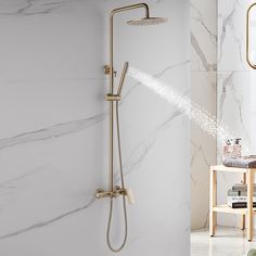 a shower head and hand shower in a white bathroom with marbled walls, flooring and furniture