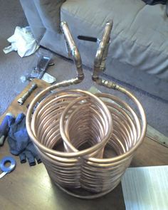 a bunch of wicker baskets sitting on top of a wooden table next to tools