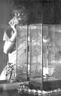 a woman standing in front of a display case