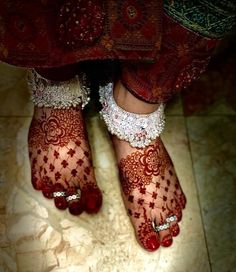 the feet are decorated with henna and jewels