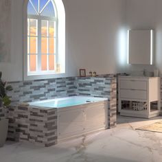 a bathroom with a tub, sink and toilet next to a large window on the wall