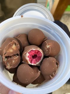 a white bowl filled with chocolate covered fruit