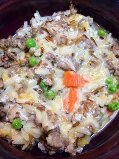 a bowl filled with meat and vegetables on top of a table