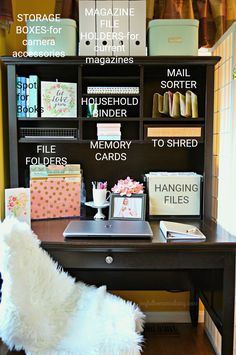 a white chair sitting in front of a desk with lots of books and magazines on it