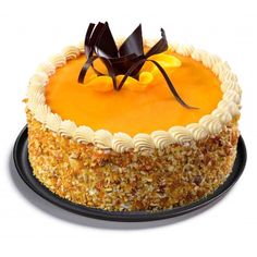 an orange cake with white frosting and chocolate decorations