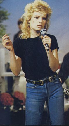 a woman standing in front of a microphone