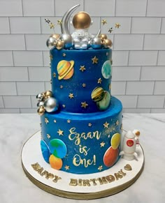 a blue birthday cake with planets and stars on it