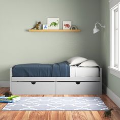 a child's bedroom with green walls and wooden floors