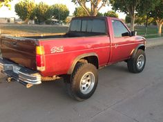 a red pick up truck parked on the street