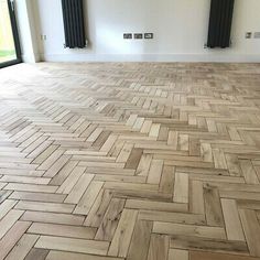 an empty room with wood flooring and radiator heaters on the wall