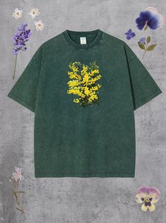 a green t - shirt with yellow flowers on it