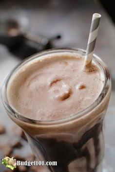 a smoothie is in a glass with a straw sticking out of it's top