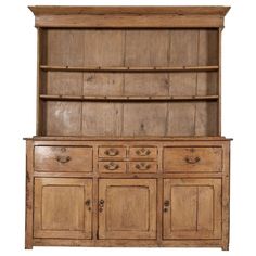 an old wooden hutch with drawers and cupboards