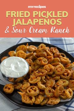 fried pickled jalapenos and sour cream ranch on a black platter