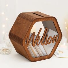 a wooden business card holder with the word nelson cut out in it's center