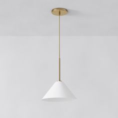 a white and gold pendant light hanging from a ceiling in a living room or kitchen