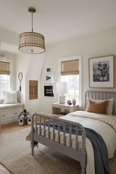 a bed room with a neatly made bed next to two windows and a rug on the floor