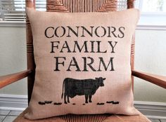 a pillow that says, connor's family farm on the back of a chair