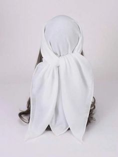 a person wearing a white cloth covering their head