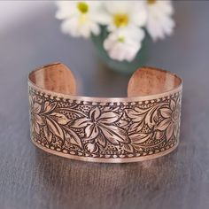 COPPER Bracelet, Copper Jewelry, Solid COPPER Cuff, Embossed Daisy Design, Copper Cuff Bracelet, Copper Cuff Bracelet, Embossed Copper Cuff □ Antiqued Copper Cuff - 1 Piece □ Width: 1 inch wide □ Length: 6.5 inches - adjustable □ Embossed Daisy Design SOLID COPPER, not plated Stunning detail on these beautiful embossed cuffs. These are very sturdy but adjustable The tooling dates back to the 1940s and cannot be duplicated in today's market. Stamped 'solid copper' on the inside. Unlike my raw cuff collection, these special pieces are hand antiqued, hand polished and have a baked lacquer coating for a long lasting look and durability. They have a beautiful embossed daisy design on a solid copper adjustable cuff bracelet and are proudly Made in the USA. To keep the beautiful lacquer finish & Rose Gold Cuff Bracelet Gift, Rose Gold Cuff Bracelet As A Gift, Daisy Design, Copper Cuff Bracelet, Copper Cuff, Copper Bracelet, Pure Copper, Copper Jewelry, Antique Copper