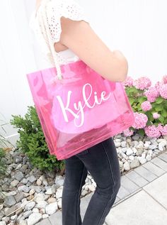 Our personalized Tote Bags are perfect for bachelorette parties, or as a thank you gift to your bridesmaids to fill with all the things! We also love these for birthdays, girls trips, to throw a towel in for the beach, or for everyday grocery shopping! ♡ These clear tote bags measure approximately 13.5*3.75*11.5 (L*W*H) ‼  Totes are personalized with professional permanent vinyl.  HOW TO ORDER: 1. Select Tote Bag Color 2. Select Font 3. Note Text and Vinyl Color in Personalization Box 4. Add to Clear Summer Bags Ideal For Gifts, Trendy Personalized Bags For Personal Use, Customizable Bags For Gifts, Customizable Bags For Gift, Trendy Customizable Bags For Personal Use, Trendy Customizable Bags For Gifts, Customizable Rectangular Shoulder Bag, Customizable Rectangular Bags, Pink Shoulder Bag For Mother's Day Gift