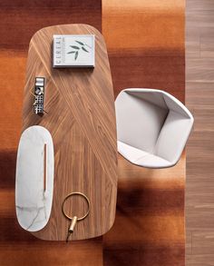 an overhead view of a wooden table with a phone on it