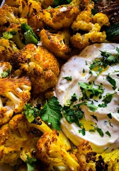 a white plate topped with cauliflower covered in ranch dressing