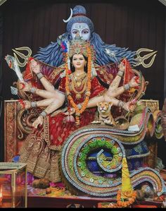 a statue of the hindu god sitting on top of a table