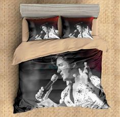 a black and white photo of a woman singing into a microphone on a bed with two pillows