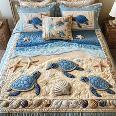 a bed with blue sea turtles and seashells on the comforter is shown