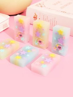 five soaps with stars on them sitting next to a box and some other items