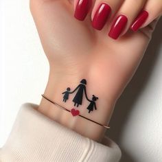 a woman's hand with a tattoo on her wrist holding a red manicure