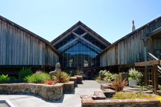 an outside view of a building with many plants