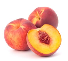 three peaches sitting next to each other on a white surface