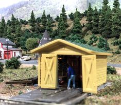 there is a small yellow shed with a man in it