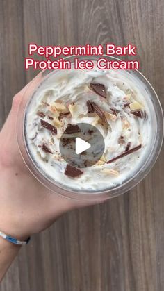 someone holding up a glass with ice cream and chocolate toppings on it, text reads peppermint bark protein ice cream