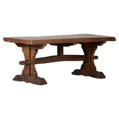 an old wooden table with two legs and one leg extended to the side, against a white background