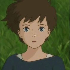 an anime character with short hair and blue eyes looks at the camera while standing in front of green grass