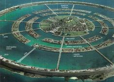 an aerial view of a circular city with lots of buildings and water around it,