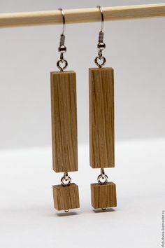 the earrings are made out of wood and have square beads hanging from each earring