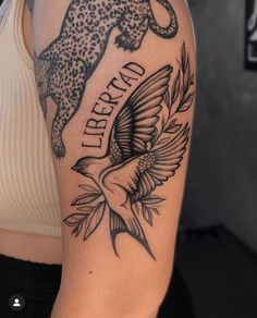 a woman with a tattoo on her arm that says liberty and an image of a cheetah