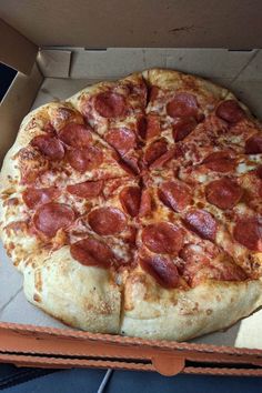 a large pepperoni pizza in a box