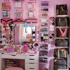 a room filled with lots of pink and white accessories on shelves next to a mirror