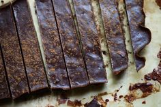 pieces of chocolate sitting on top of a cutting board