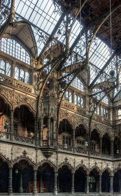 the inside of an old building with lots of windows and stone flooring in it