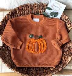 **I can ship this sweater out in ONE day Thank you for supporting my small business  Follow me here, on Instagram, Facebook, & Pinterest.  I have this cute, pumpkin embroidered, rust color cotton baby sweater. 🎃 Adorable for baby's first Halloween!!  It's a size 9-12 months.  This pullover style sweater is loose fitting.  Roll up the cuffs to make even cuter! Check out my other listing for my personalized baby pullover sweaters. They are such a unique gift for that special baby or child They ca Embroidered Pumpkin, Baby Jumpers, Pumpkin Sweater, Thanksgiving Sweater, Baby First Halloween, Pumpkin Thanksgiving, Iron On Fabric, Baby Sweater, Cozy Autumn