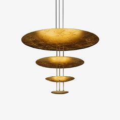 an abstract chandelier with three circular lights hanging from it's sides, suspended in gold leafed metal