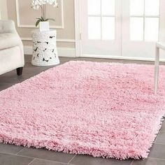 a pink area rug in a living room