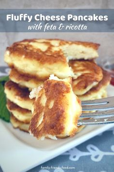 fluffy cheese pancakes with feta and ricotta on a white plate next to a fork