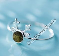 Ring Details- Stone- Natural Moldavite from Czech Republic Metal- 925 Sterling Silver Stone Dimension- 7 mm  Cut Type-Round ♥ What is Moldavite? Moldavite is a mysterious green glass stone, classed in the tektite family and found only in the Czech Republic. An ancient meteorite impact occurred on our planet about 15 million years ago, which gave birth to a gemstone with many legends, myths, and secrets. ♥ Benefits of Moldavite? Moldavite is a mystical stone that promotes spiritual transformation. It's known for its unique ability to immediately open a portal to the divine. Said to be a stone of metaphysical healing, Moldavite brings about elevated energy levels and inner peace. In recent years, the Internet has exploded with cheap and completely fake Moldavite. The market for this mysterio Moldavite Ring, Moldavite Jewelry, Spiritual Transformation, Metaphysical Healing, Green Glass, Czech Republic, Women's Jewelry, Silver Fashion, Wedding Rings Engagement